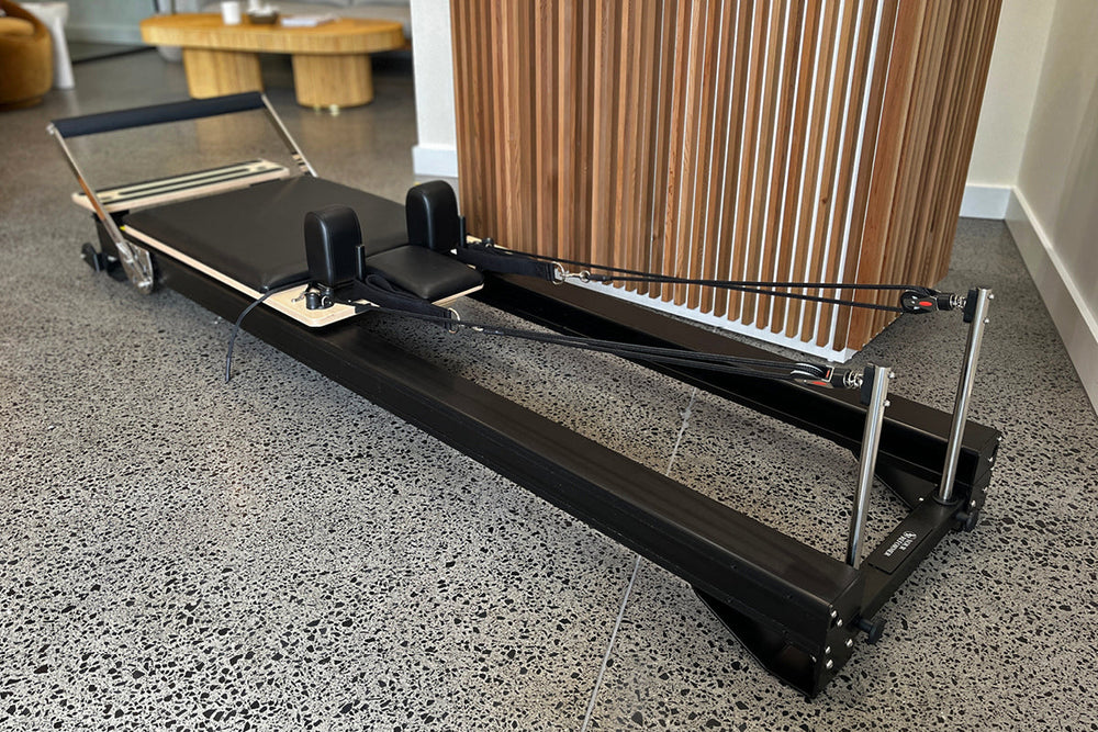 Black Studio X Pilates Reformer - Full Side View in Modern Living Room | Your Reformer