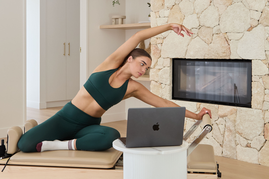 Pilates Education student practicing on the Reformer