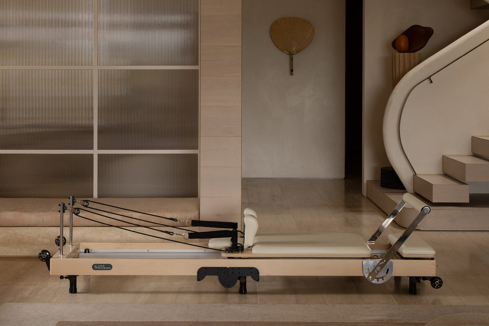 YR Original Folding Reformer - Woman Practicing Pilates in Modern Living Room | Your Reformer