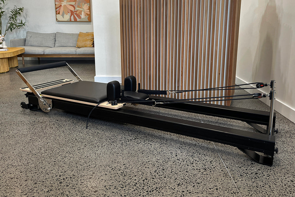 Black Studio X Pilates Reformer - Full Side View in Modern Living Room | Your Reformer
